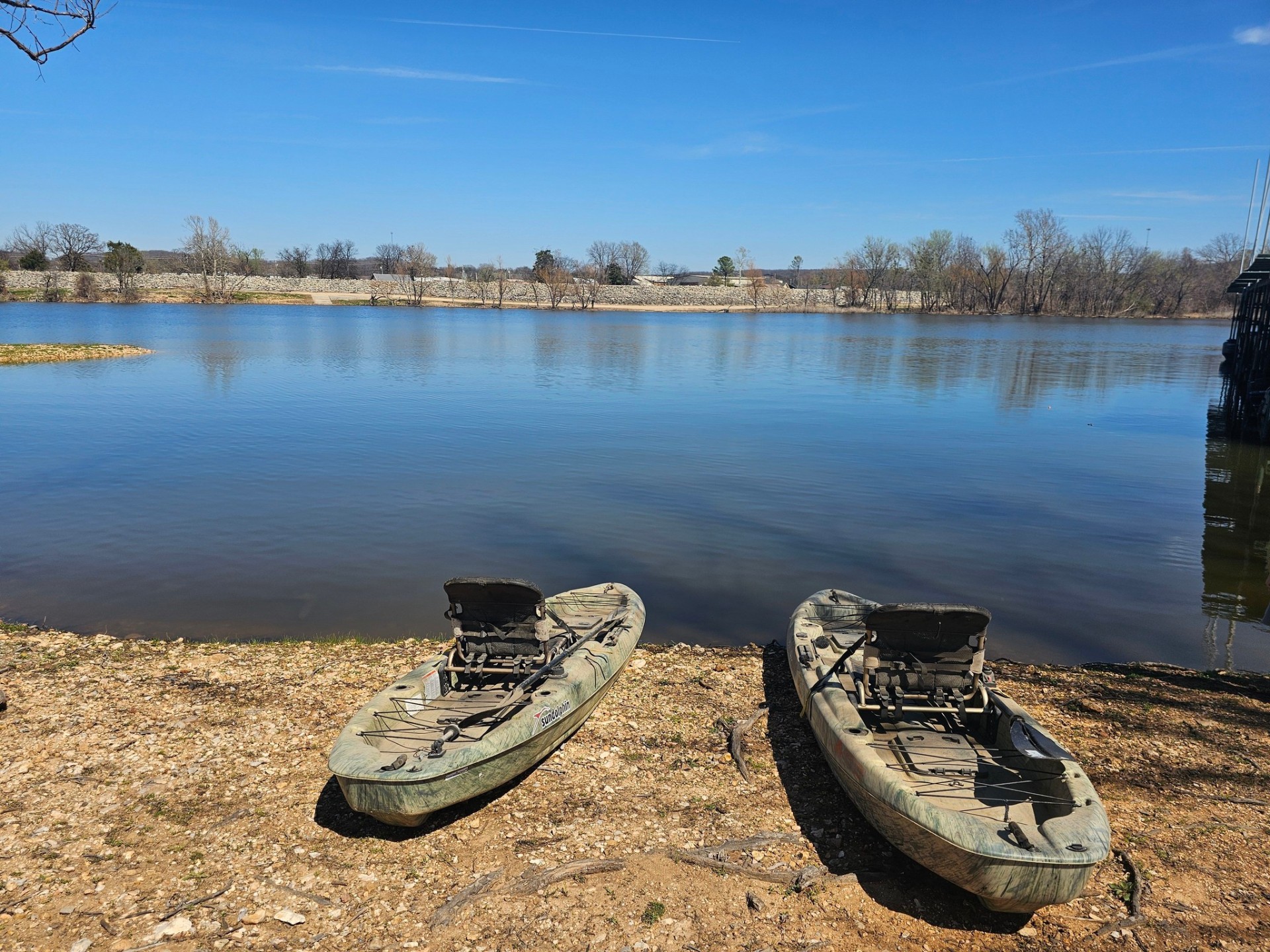 Kayaks resting at the water's edge on Lake Hudson
