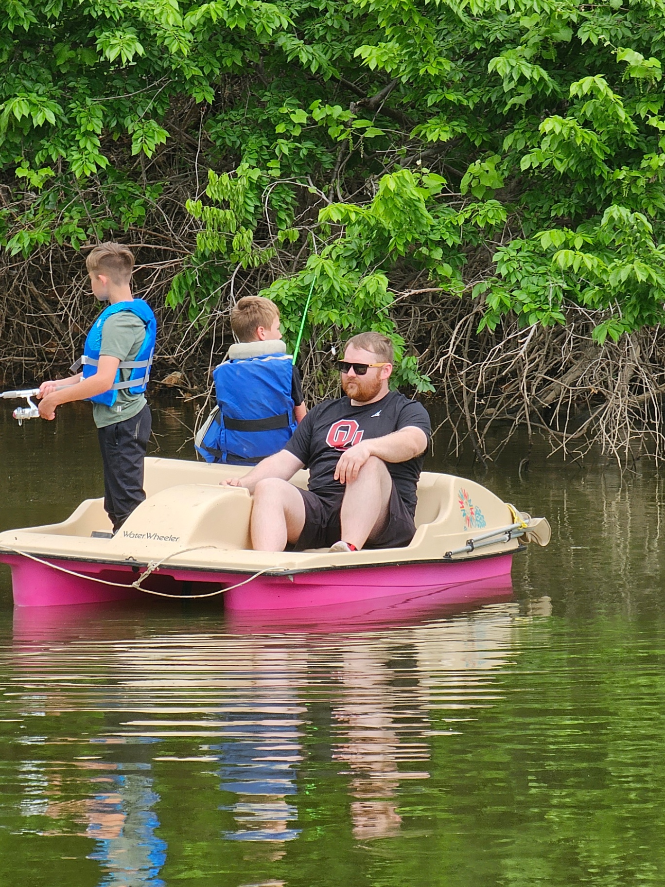 Family fishing from a pedal boat on the cove